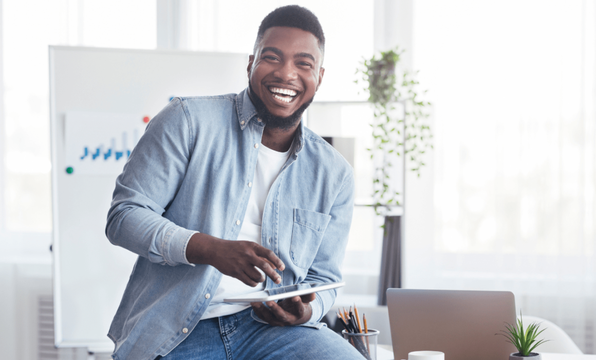 Smiling man celebrating the success of hiring a marketing assistant to support a lingerie brand’s growth.