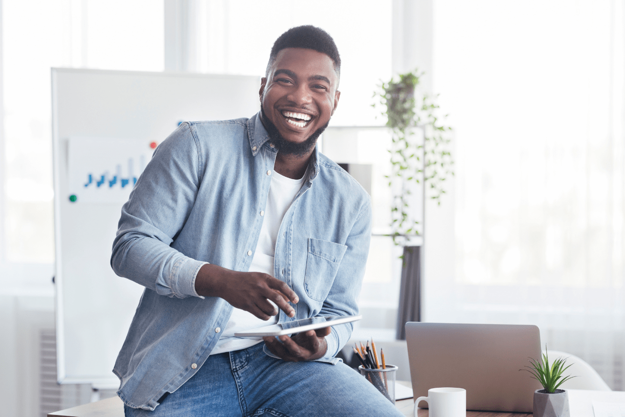 Smiling man celebrating the success of hiring a marketing assistant to support a lingerie brand’s growth.