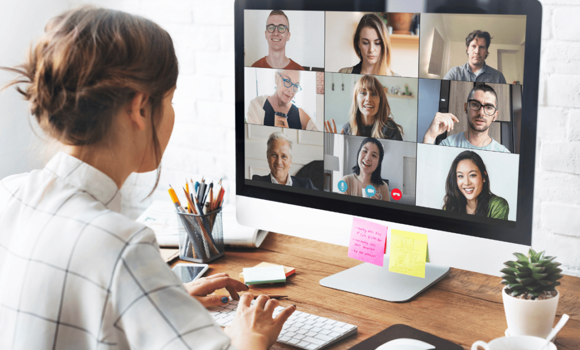 A woman in a virtual remote meeting, working from home on her laptop.