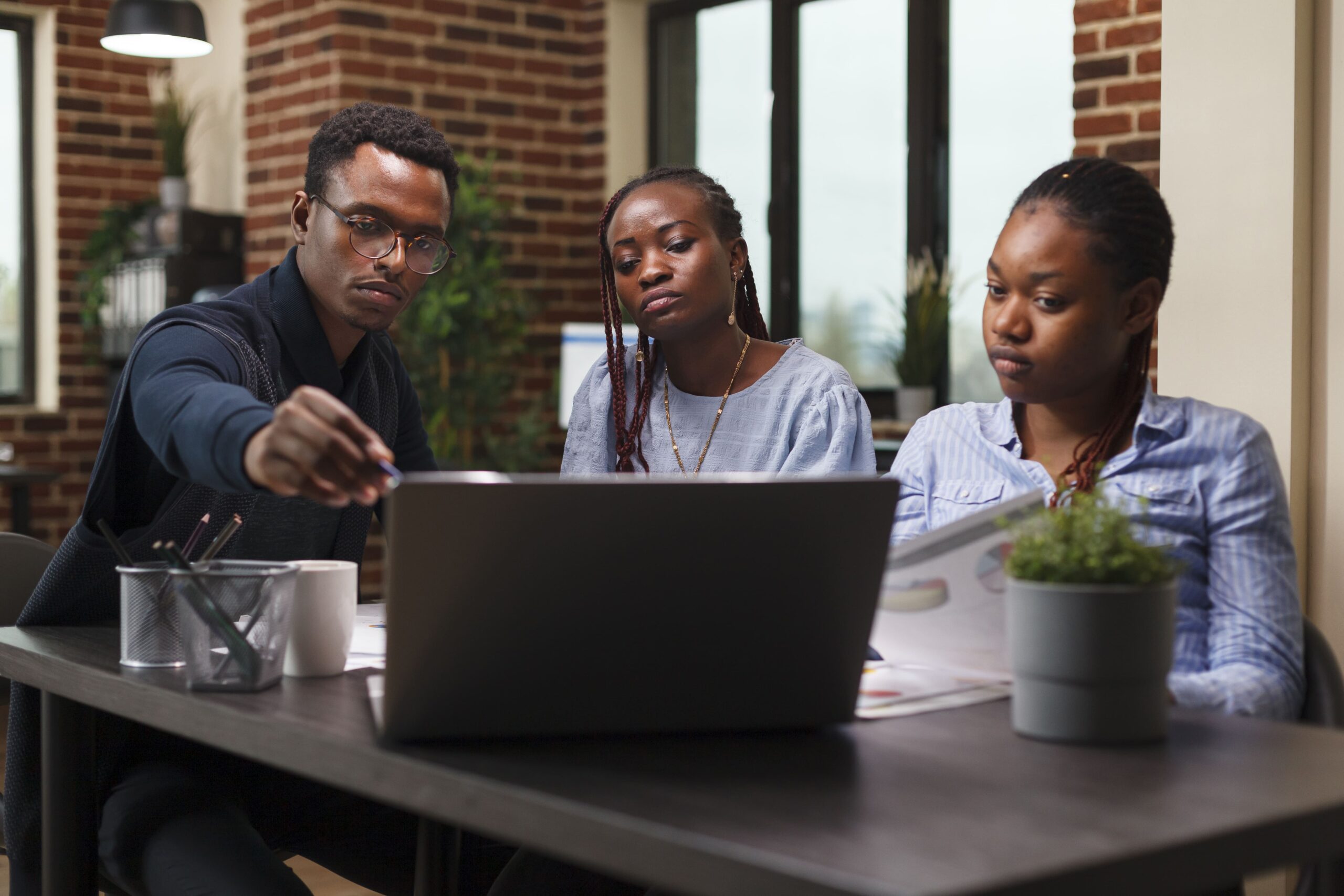 Nigerian remote team at a work station during a meeting with  their UK based employer
