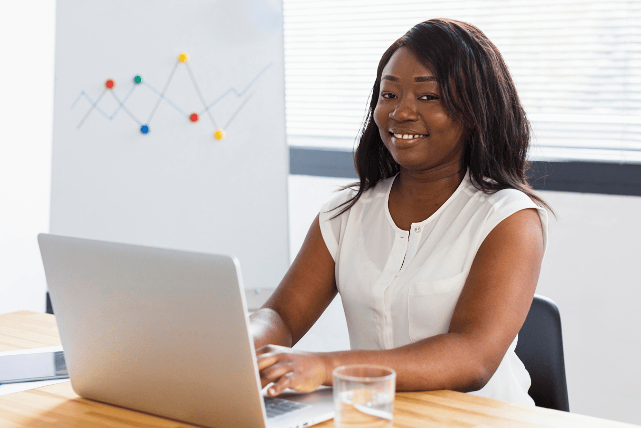 A Marketing Assistant working on a laptop, managing social media content and marketing campaigns.